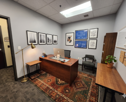office with desk, rug, wall decor